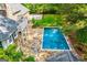 Aerial view of the pool and the patio, next to the backyard and home at 115 Champion Dr, Carrollton, GA 30116