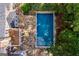 A beautiful rectangle pool is surrounded by a stone patio and lush greenery at 115 Champion Dr, Carrollton, GA 30116