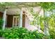 Inviting covered porch with decorative columns and ceiling fans at 115 Champion Dr, Carrollton, GA 30116