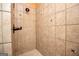 Close up view of tiled shower with bronze fixtures and a decorative accent tile pattern at 115 Champion Dr, Carrollton, GA 30116