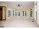 Sunroom with white tile flooring, neutral walls and a ceiling fan at 115 Champion Dr, Carrollton, GA 30116