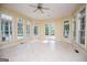 Spacious sunroom with many windows and tile floors; also providing access to the outside pool at 115 Champion Dr, Carrollton, GA 30116
