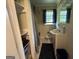 A full bathroom features a shower with curtain, toilet, sink and cabinet, mirror, and some storage at 1711 Mckenzie Dr, Decatur, GA 30032