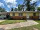 Modest single story home featuring brick and wood with a covered carport and concrete front walk at 1711 Mckenzie Dr, Decatur, GA 30032
