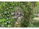 Secluded backyard patio with stone pathway surrounded by flowering shrubs, offering a tranquil outdoor space for relaxing and entertaining at 100 Rosemont, Peachtree City, GA 30269