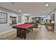 Basement living and entertainment area including a pool table, fireplace, and comfortable seating at 100 Rosemont, Peachtree City, GA 30269