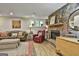 Cozy basement living space with stone fireplace, wooden mantel, and window views to the outdoors at 100 Rosemont, Peachtree City, GA 30269