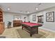 Basement entertainment area features a pool table, piano, and custom wood details at 100 Rosemont, Peachtree City, GA 30269