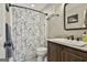 Cozy bathroom featuring a dark wood vanity and a shower with a floral shower curtain at 100 Rosemont, Peachtree City, GA 30269