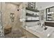 Bright bathroom with a glass shower, soaking tub, dark wood shelving with neatly stacked towels at 100 Rosemont, Peachtree City, GA 30269