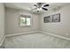 A simple bedroom featuring carpeted floors, a window, and natural lighting at 100 Rosemont, Peachtree City, GA 30269