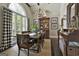 Elegant dining room featuring a wooden table, chandelier, and large arched window at 100 Rosemont, Peachtree City, GA 30269