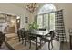 Bright dining room with a wooden table, large arched window and stylish decor at 100 Rosemont, Peachtree City, GA 30269
