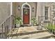 Close up of front door with potted plants and lights at 100 Rosemont, Peachtree City, GA 30269