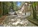 Spacious two-car garage and driveway, complemented by tasteful landscaping and mature trees at 100 Rosemont, Peachtree City, GA 30269