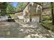 Spacious two-car garage and driveway, complemented by tasteful landscaping and mature trees at 100 Rosemont, Peachtree City, GA 30269