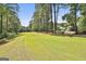 Beautiful green golf course view lined with mature trees and a clear blue sky, offering a scenic and relaxing ambiance at 100 Rosemont, Peachtree City, GA 30269
