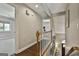 Hallway with wooden floors, a view of the stairs, and an open doorway to another room at 100 Rosemont, Peachtree City, GA 30269