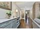 Elegant hallway featuring hardwood floors, a decorative table with lamp, and stone accent wall at 100 Rosemont, Peachtree City, GA 30269