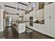 Open kitchen featuring a central island with seating, stainless steel appliances, and dark hardwood flooring at 100 Rosemont, Peachtree City, GA 30269