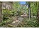 Beautifully landscaped pathway through lush greenery and mature trees at 100 Rosemont, Peachtree City, GA 30269