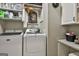 Well-equipped laundry area with modern washer and dryer, storage shelves, and neat organization at 100 Rosemont, Peachtree City, GA 30269