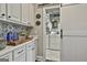 Laundry room with white cabinets, stylish backsplash, counter space, and washer/dryer hookups at 100 Rosemont, Peachtree City, GA 30269