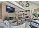 Cozy living room with a stone fireplace, vaulted ceilings, and comfortable seating at 100 Rosemont, Peachtree City, GA 30269