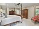 Spacious main bedroom with a four-poster bed, wood floors, and ample closet space at 100 Rosemont, Peachtree City, GA 30269