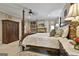 Elegant main bedroom featuring a four-poster bed, stone fireplace, and built-in shelving for a luxurious retreat at 100 Rosemont, Peachtree City, GA 30269