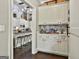 Chic pantry features white cabinets and patterned backsplash, with a view into the kitchen at 100 Rosemont, Peachtree City, GA 30269