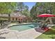 Aerial view of a home's backyard featuring a pool, patio, and landscaped grounds at 100 Rosemont, Peachtree City, GA 30269