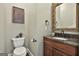 Chic powder room with a dark wood vanity, granite countertop, decorative mirror, and modern fixtures at 100 Rosemont, Peachtree City, GA 30269
