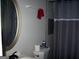 Bathroom featuring a toilet, a vanity with a mirror, and a gray shower curtain at 981 E Atlanta Rd, Stockbridge, GA 30281