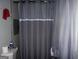 Bathroom showcasing a shower with a gray curtain and a toilet at 981 E Atlanta Rd, Stockbridge, GA 30281