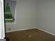 Bedroom features a bright window with nature views, carpet flooring, and natural light at 981 E Atlanta Rd, Stockbridge, GA 30281