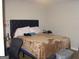 Bedroom showcasing a bed with a dark headboard and neutral bedding at 981 E Atlanta Rd, Stockbridge, GA 30281