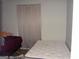 Bedroom showcasing two beds and a neutral curtain-covered window at 981 E Atlanta Rd, Stockbridge, GA 30281