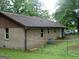 Brick home with a brown roof and a chain link fence in the background at 981 E Atlanta Rd, Stockbridge, GA 30281