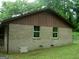 Side view of a brick home with a brown roof and a small window at 981 E Atlanta Rd, Stockbridge, GA 30281
