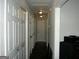 Hallway with a series of white doors and light fixtures on the ceiling at 981 E Atlanta Rd, Stockbridge, GA 30281