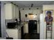 Cozy kitchen with white cabinets, black appliances, and granite countertops at 981 E Atlanta Rd, Stockbridge, GA 30281