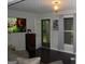 Cozy living room with dark floors, a mounted television, and an exterior door at 981 E Atlanta Rd, Stockbridge, GA 30281