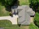 Aerial view of a home surrounded by a lush green lawn at 211 English Oaks Ln, Mcdonough, GA 30253
