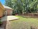 Backyard features a patio, fire pit, and landscaped retaining wall at 211 English Oaks Ln, Mcdonough, GA 30253