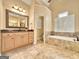 This bathroom features a large vanity, soaking tub, and lots of natural light at 211 English Oaks Ln, Mcdonough, GA 30253