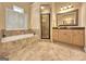 This elegant bathroom features a soaking tub, glass enclosed shower, and large vanity at 211 English Oaks Ln, Mcdonough, GA 30253
