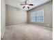 Bedroom featuring neutral carpet, ceiling fan, and a large window at 211 English Oaks Ln, Mcdonough, GA 30253
