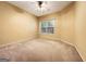 A light-filled bedroom features neutral carpet, ceiling fan, and a bright window at 211 English Oaks Ln, Mcdonough, GA 30253