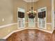 Bright dining area with a chandelier, neutral walls, and large windows with decorative valances at 211 English Oaks Ln, Mcdonough, GA 30253